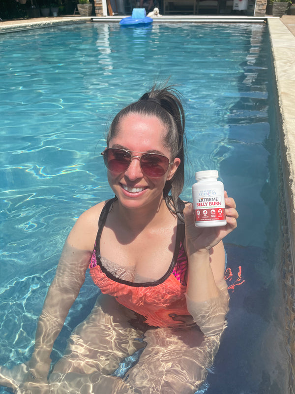 Customer holding Extreme Belly Burn Capsules