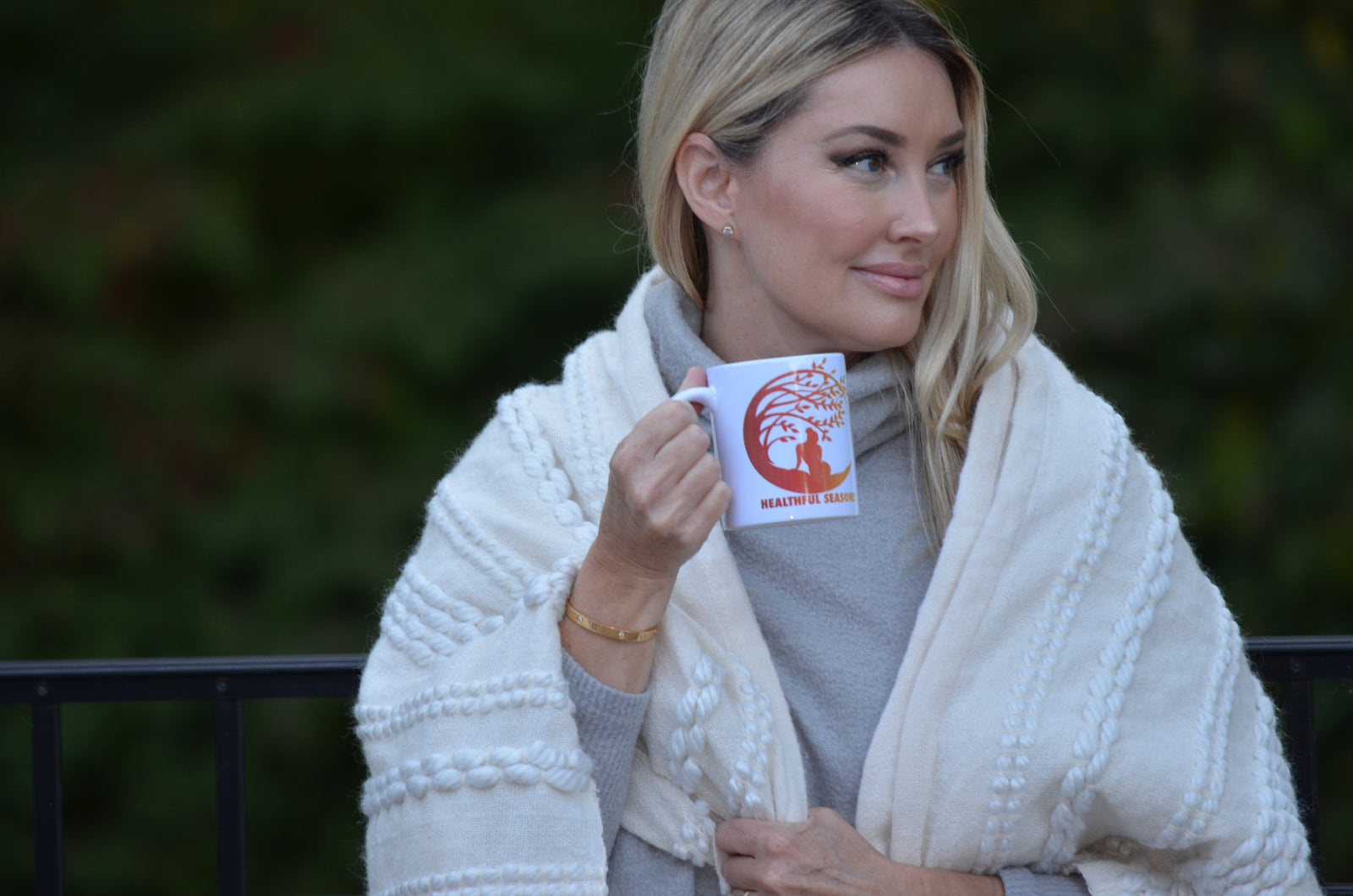 Healthful Seasons co-founder holding a warm mug outdoors in fall
